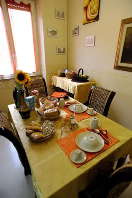 a dining room table with plates of food on it at La Casa Romana in Rome