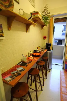 a kitchen with a long counter with stools in it at La Casa Romana in Rome