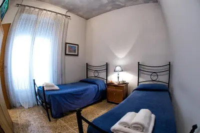 a bedroom with two beds and a window at Giornate Romane in Rome