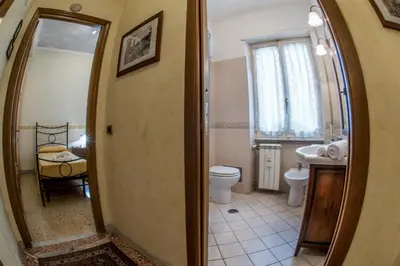 a bathroom with a toilet and a sink and a mirror at Giornate Romane in Rome
