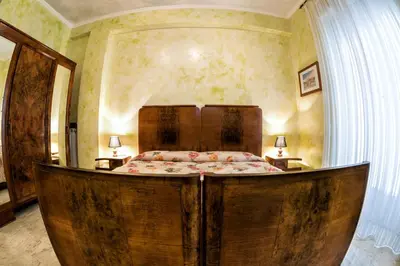 a bedroom with a large wooden bed in a room at Giornate Romane in Rome