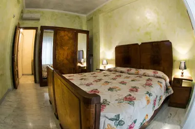 a bedroom with a bed with a floral bedspread at Giornate Romane in Rome