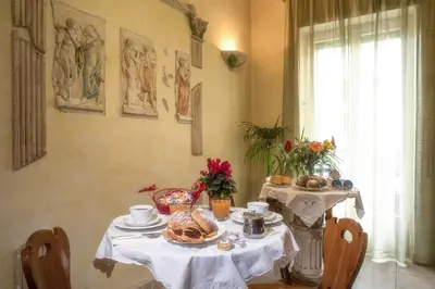 a table with a plate of food on it at Giornate Romane in Rome