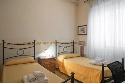 two beds in a room with towels on them at Giornate Romane in Rome