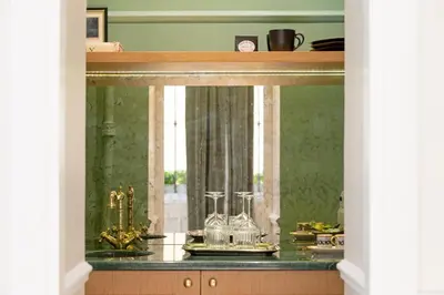a room with a counter with a window and a table at Casa Cucu Piazza del Popolo in Rome