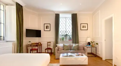 a bedroom with a bed and a couch and a table at Casa Cucu Piazza del Popolo in Rome