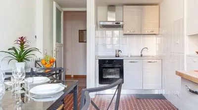 a kitchen with a table with chairs and a sink at Otium Maecenatis Apartments in Rome