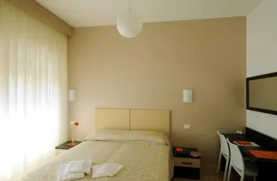 a bedroom with a bed with two towels on it at Honey Rooms in Rome