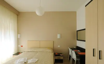 a bedroom with a bed and a desk and a television at Honey Rooms in Rome