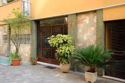 a building with two potted plants in front of it at Honey Rooms in Rome