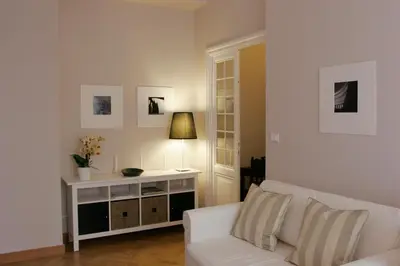 a living room with a white couch and a table at Roman Suite in Rome