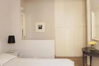 a bedroom with two beds and a mirror at Roman Suite in Rome
