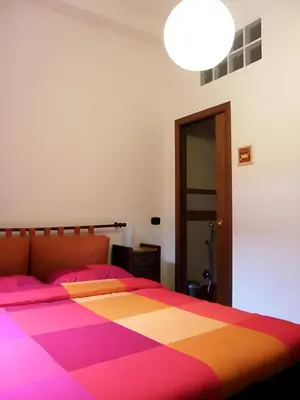 a bedroom with a large bed with a colorful blanket at Breakfast In Bed in Rome
