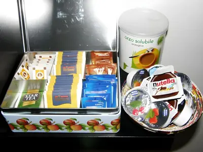 a lunch box with food and drinks and a drink at Breakfast In Bed in Rome