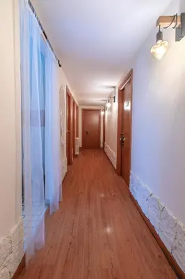 a hallway with a long corridor with a hard wood floor and a corridorngthngth at BB Danilo in Rome