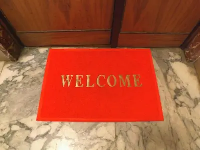 a red welcome book sitting on a marble floor at Sepulveda in Rome