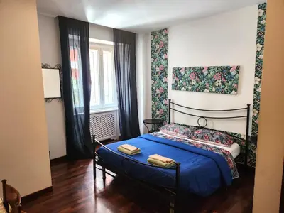 a bedroom with a blue bed and a window at Sepulveda in Rome