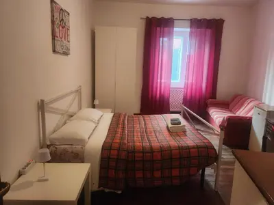 a small bedroom with a bed and a couch at Sepulveda in Rome