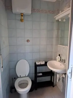 a bathroom with a toilet and a sink at Sepulveda in Rome