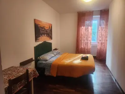 a bedroom with a bed with an orange blanket at Sepulveda in Rome