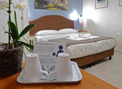 a room with a bed and a table with a tray with a tea set at Re Monti in Rome