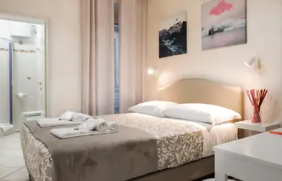 a bedroom with a bed with towels on it at Re Monti in Rome