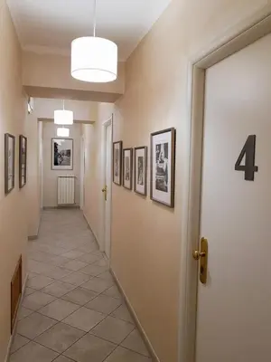 a hallway with a row of pictures on the walls at Re Monti in Rome
