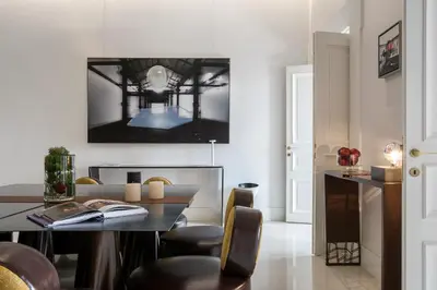 a dining room with a table and chairs at Piazza di Spagna 9 in Rome