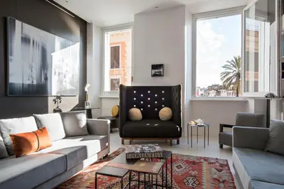 a living room with a couch and a chair at Piazza di Spagna 9 in Rome