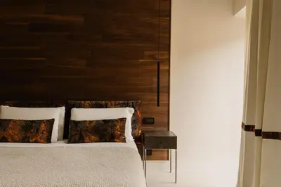 a bedroom with a bed with a wooden headboard at Piazza di Spagna 9 in Rome