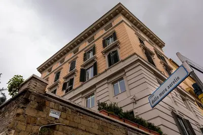 a building with a street sign in front of it at All'Ombra Del Cupolone Guest House in Rome