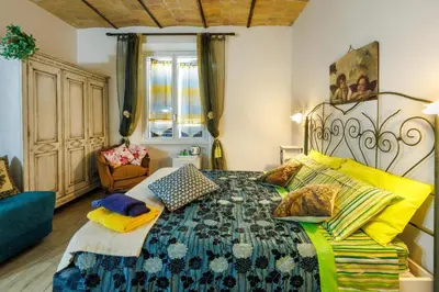 a bedroom with a large bed with colorful pillows at All'Ombra Del Cupolone Guest House in Rome
