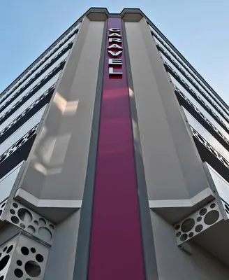 a tall building with a long escalator up to the sky at Hotel Caravel in Rome