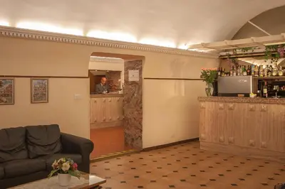 a room with a bar and a man in the mirror at Hotel Tirreno in Rome