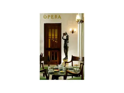 a statue of a woman standing next to a table at Hotel Quirinale in Rome