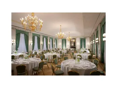 a banquet hall with white tables and chairs and chandeliers at Hotel Quirinale in Rome