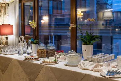a table with pies and other food on it at Hotel Forum in Rome
