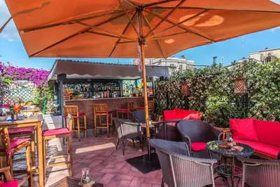 a table on a balcony with a view of the city at Hotel Forum in Rome