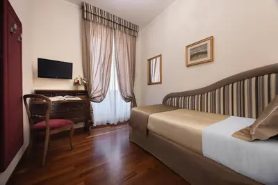 a bedroom with a bed and a side table at Hotel Forum in Rome