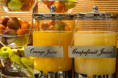 two jars of orange juice with signs on them at Hotel Mascagni in Rome