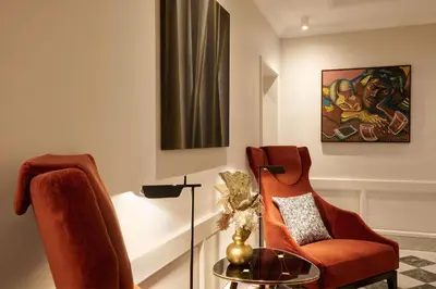 a living room with a chair and a table at Hotel Mascagni in Rome