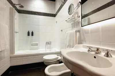 a white bathroom with a sink and a toilet at Hotel Mascagni in Rome