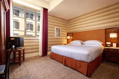 a hotel room with a bed and a television at Hotel Mascagni in Rome