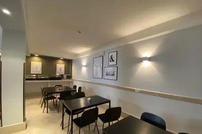a restaurant with tables and chairs and a counter at Hotel King in Rome