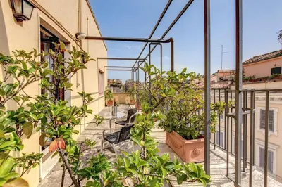 a balcony with potted plants on a building at Hotel King in Rome