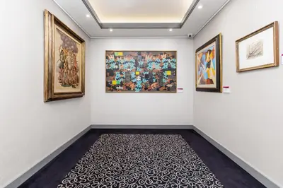 a room with paintings on the wall and a carpet at Hotel Artemide in Rome