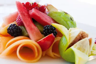 a pile of fruits and vegetables on a plate at Hotel Artemide in Rome