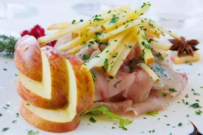 a sandwich with meat and cheese on a white plate at Hotel Artemide in Rome