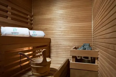 a sauna with a bucket and towels in it at Hotel Artemide in Rome