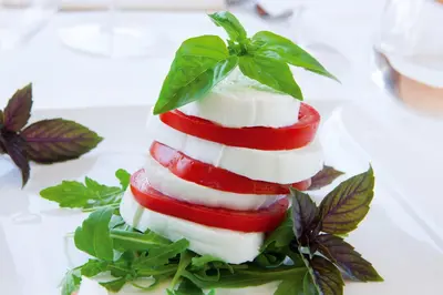 a stack of food on a plate with leaves at Hotel Artemide in Rome